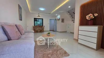 Spacious living room with modern decor and cozy ambiance in a stylish home.