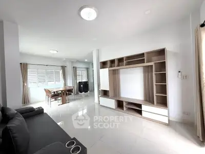 Spacious modern living room with sleek furniture and ample natural light.