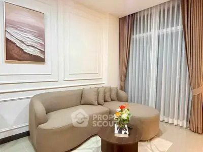 Elegant living room with stylish sofa and floor-to-ceiling curtains, perfect for modern comfort.