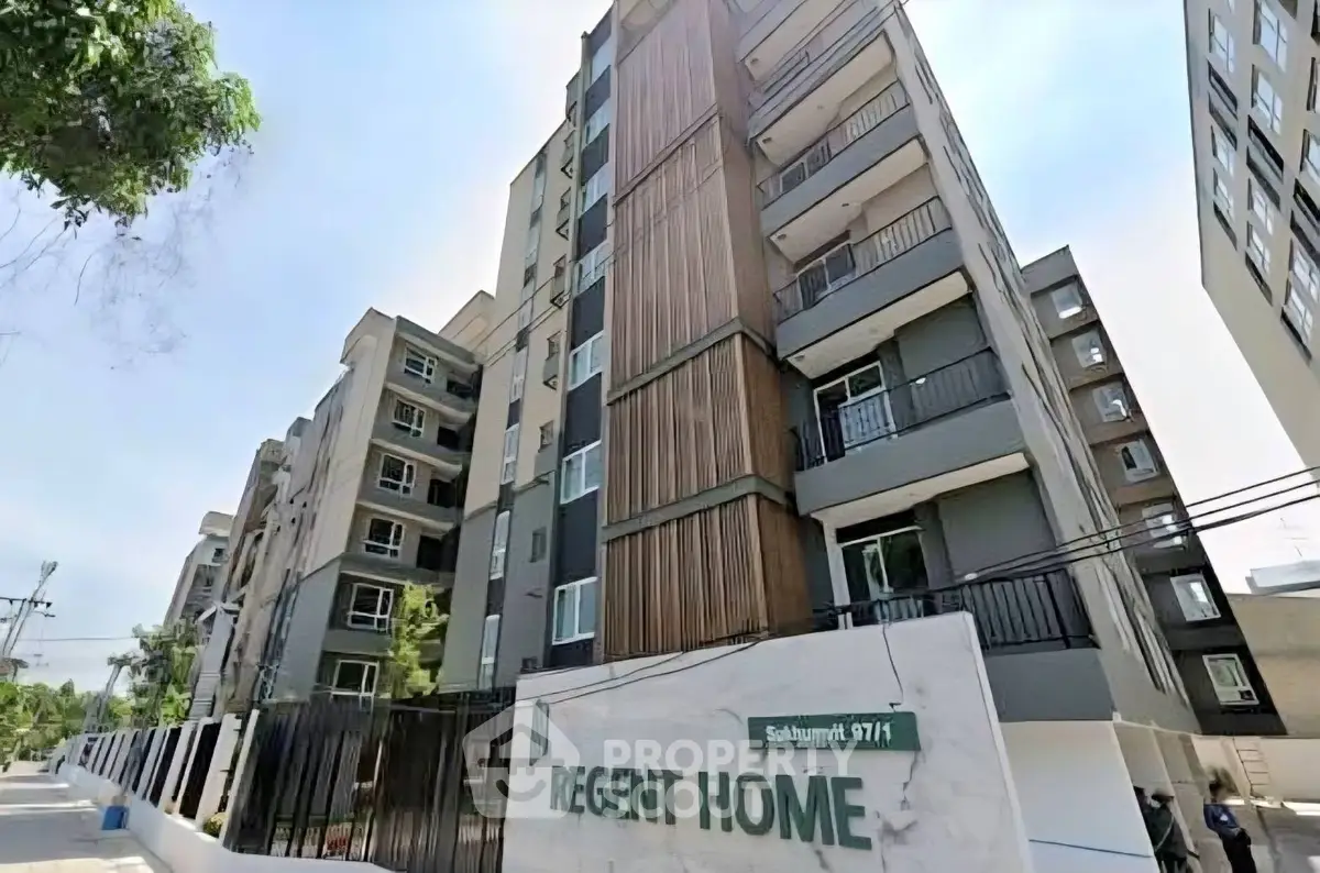 Modern condominium building exterior with balconies and contemporary design.
