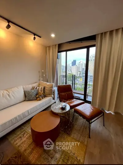 Modern living room with city view, cozy seating, and stylish decor