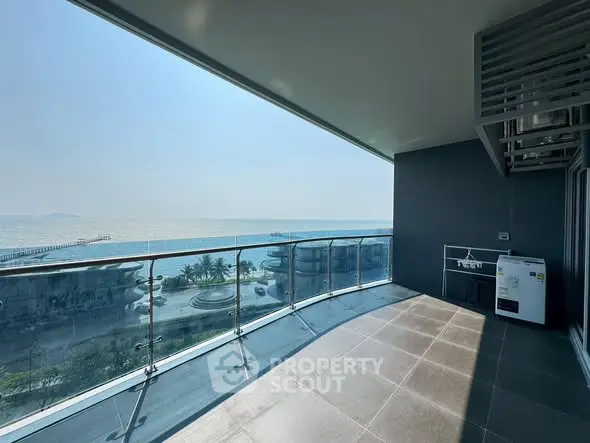 Spacious balcony with stunning ocean view in modern high-rise apartment