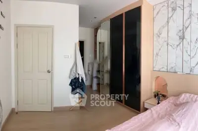 Spacious bedroom with modern wardrobe and stylish decor