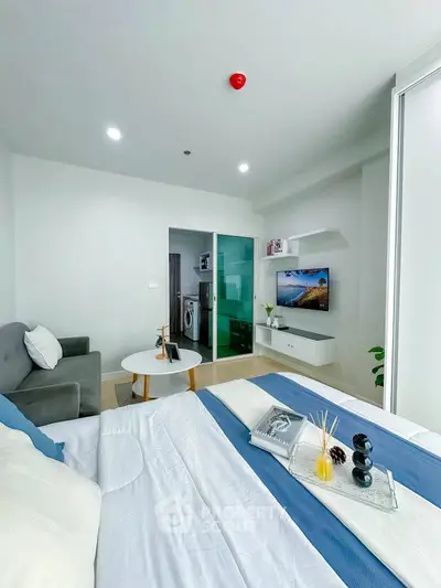 Modern living room with stylish decor and cozy ambiance, featuring a sleek TV setup and comfortable seating.