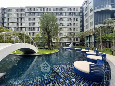 Modern apartment complex with stylish pool and lush greenery