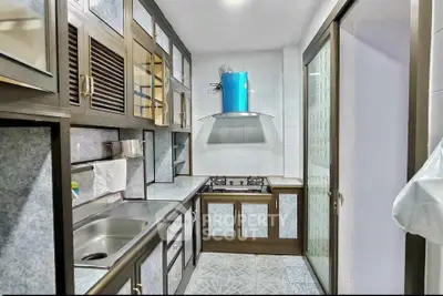 Modern kitchen with sleek cabinetry and gas stove in compact layout