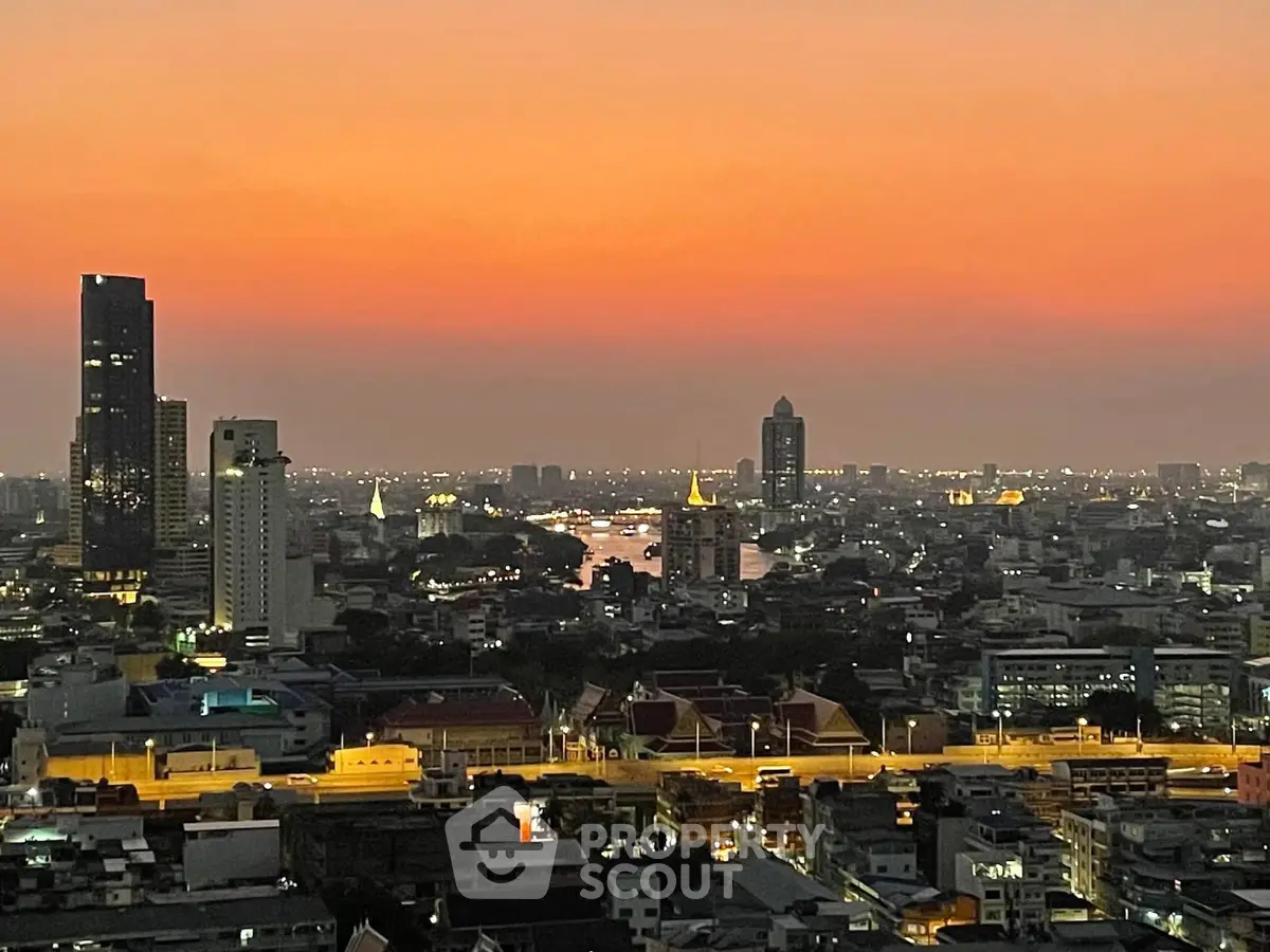 Stunning cityscape view at sunset with vibrant skyline and river, perfect for urban living enthusiasts.