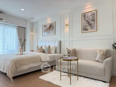 Luxurious bedroom with elegant decor and cozy seating area, perfect for relaxation and comfort.