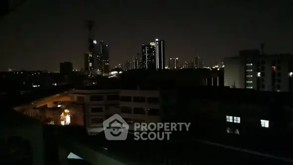 Stunning night cityscape view from a high-rise building balcony.