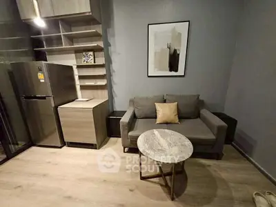 Modern living room with stylish furniture and sleek kitchen area, perfect for urban living.