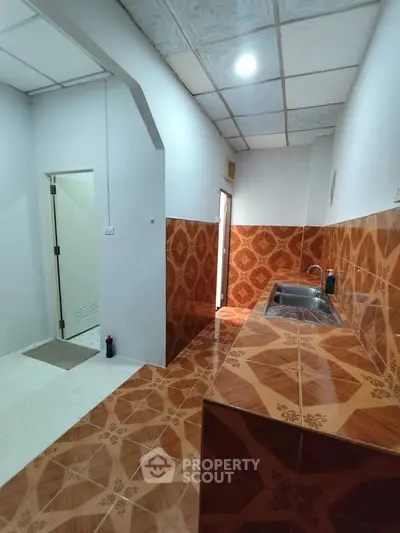 Spacious kitchen with unique tile design and modern sink area