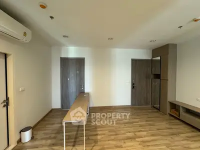 Modern minimalist living room with wooden flooring and sleek furniture