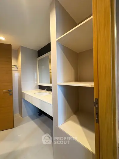 Modern bathroom with sleek shelving and elegant sink design