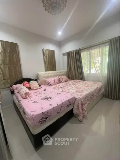 Cozy bedroom with plush bed and elegant curtains, perfect for restful nights.