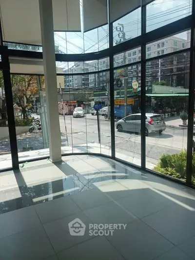 Spacious commercial space with large windows offering street view, ideal for retail or office use.