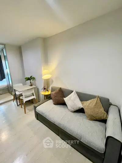 Cozy living room with modern sofa and stylish decor in a contemporary apartment.