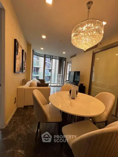 Luxurious living room with elegant chandelier and modern decor in high-rise apartment