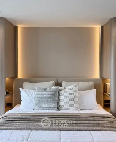 Luxurious modern bedroom with elegant lighting and plush bedding