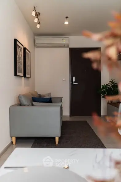Cozy living room with modern decor and air conditioning in a stylish apartment.