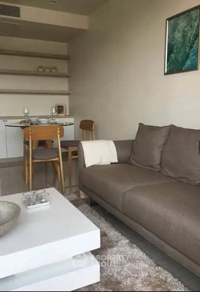 Modern living room with cozy sofa, stylish dining area, and elegant decor.