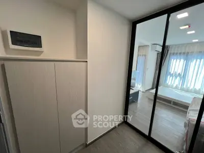 Modern bedroom with mirrored closet and natural light