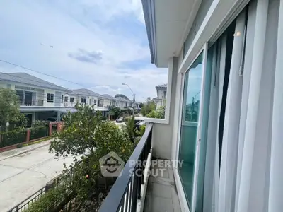Charming residential street view from a cozy balcony in a modern neighborhood.