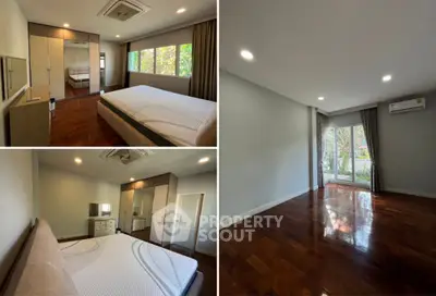 Spacious bedroom with large windows and wooden flooring
