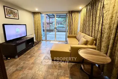 Spacious living room with modern decor and large windows offering natural light.