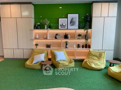 Modern living room with green accent wall and cozy seating area