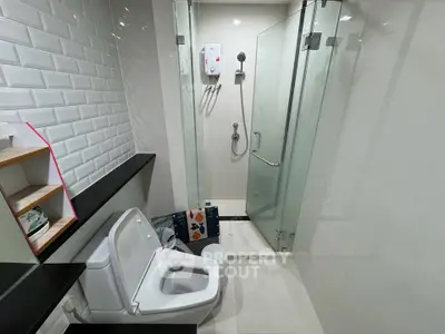 Modern bathroom with glass shower and sleek tile design