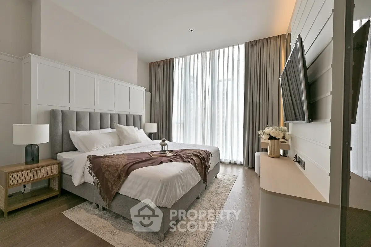 Luxurious bedroom with elegant decor and large windows for natural light