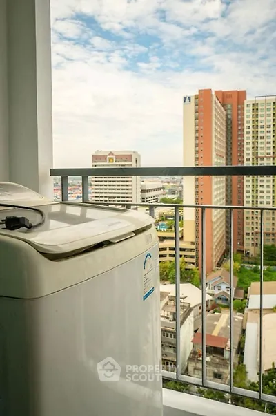 High-rise balcony with washing machine and cityscape view