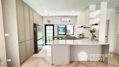 Modern kitchen with sleek cabinetry and island in bright open layout