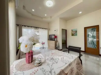 Charming living room with elegant decor and natural light, perfect for relaxation and entertainment.