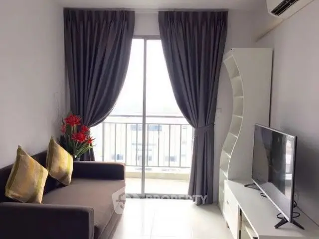 Cozy living room with modern decor and balcony view, perfect for relaxation.