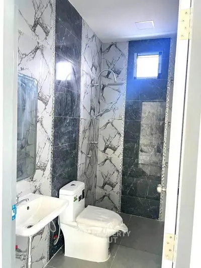 Modern bathroom with marble tiles and sleek fixtures in a contemporary home.