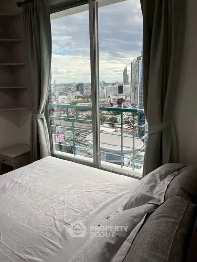 Stunning city view from a modern bedroom with large windows and elegant curtains.