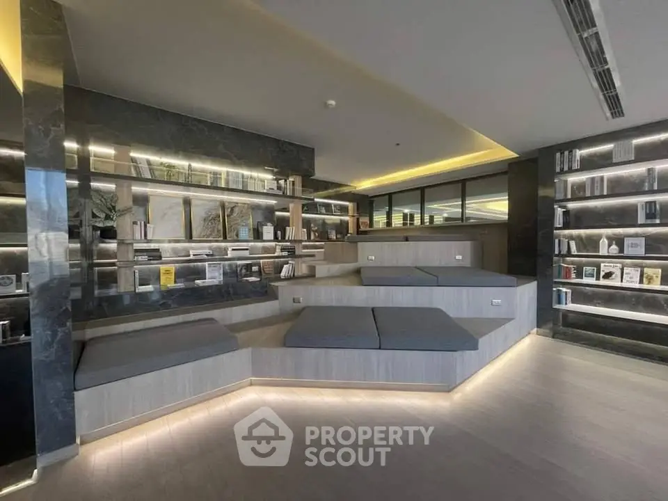 Modern library with sleek design and ambient lighting in a luxurious building.