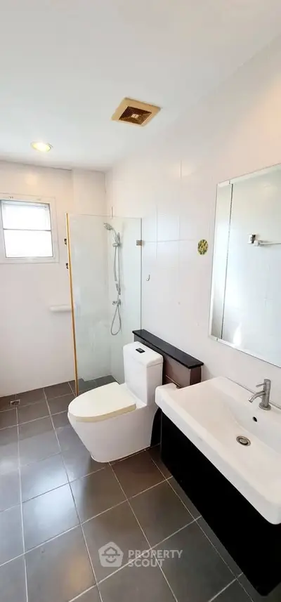Modern bathroom with sleek fixtures and glass shower enclosure
