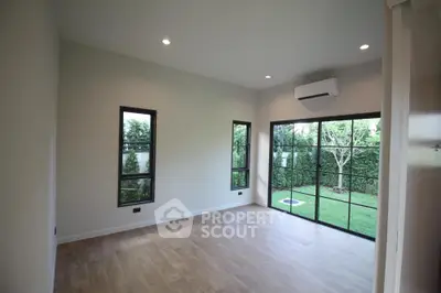 Spacious modern living room with large windows and garden view