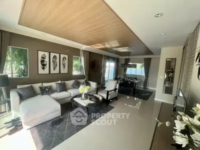 Elegant living room with modern decor and natural light, featuring a cozy seating area and stylish dining space.