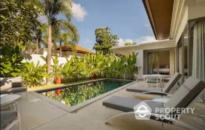 Luxurious villa with private pool and lush garden, perfect for relaxation and tropical living.