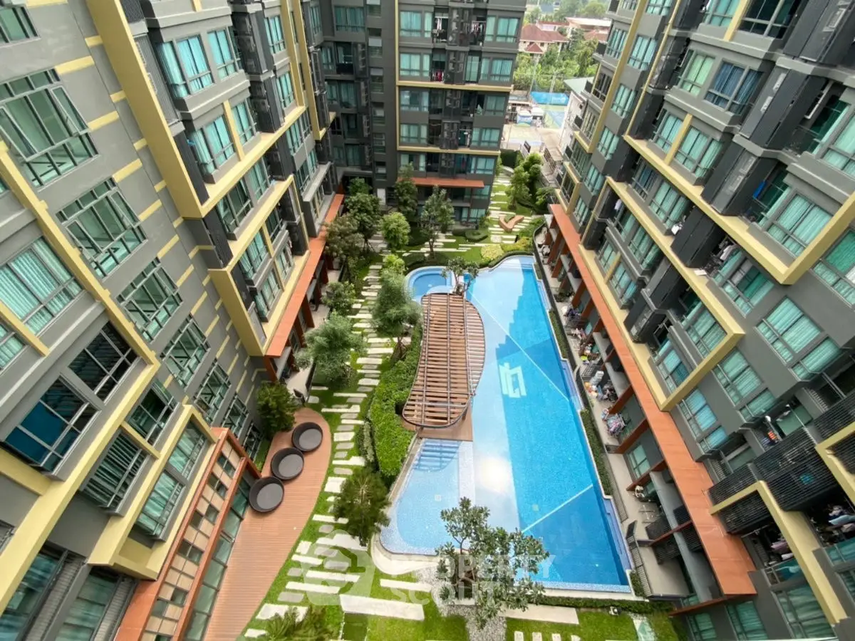 Modern apartment complex with stunning pool and lush garden view