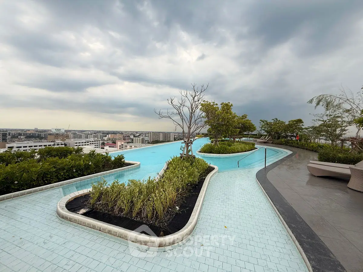 Stunning rooftop pool with panoramic city views and lush greenery.