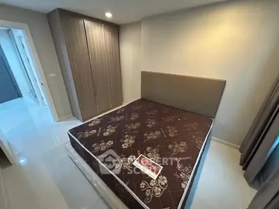 Spacious bedroom with modern wardrobe and comfortable bed in a stylish apartment.