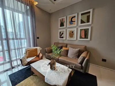 Stylish living room with modern decor and large windows in a high-rise apartment.