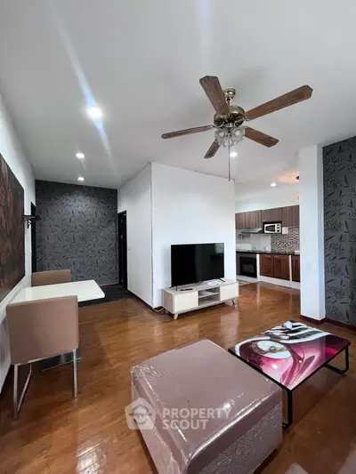 Spacious living room with modern decor and open kitchen layout