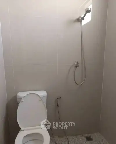 Minimalist bathroom with shower and toilet in modern apartment