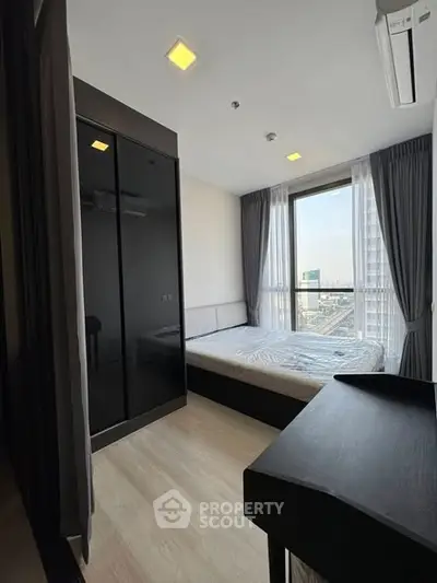 Modern bedroom with city view and sleek black wardrobe