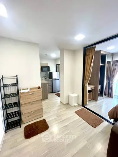 Modern apartment interior with open layout, featuring a cozy kitchen and stylish living area.